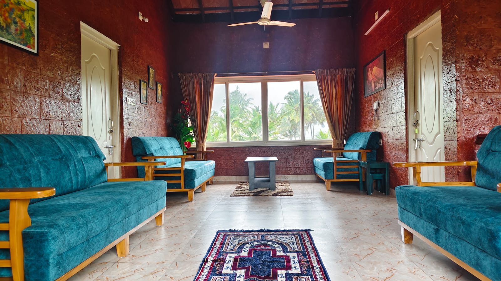 The lounge with velvet sofas and sea-view window